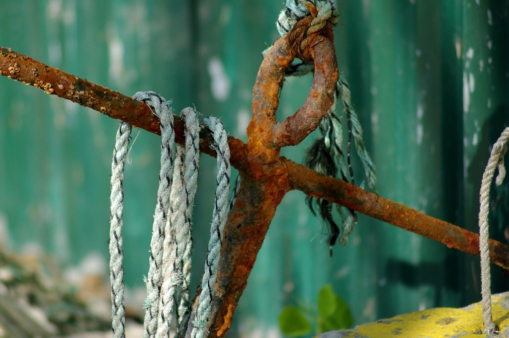 A close up of a rusty anchor on a rope. Anchor sea port. - PICRYL