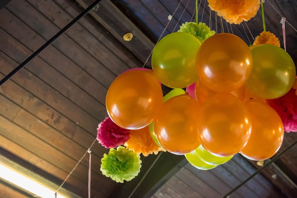 A bunch of balloons hanging from a ceiling. Balloon party