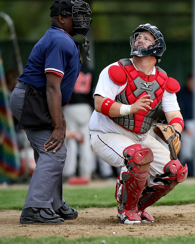 Download A Baseball Player Wearing A Gold Catchers Mask Wallpaper