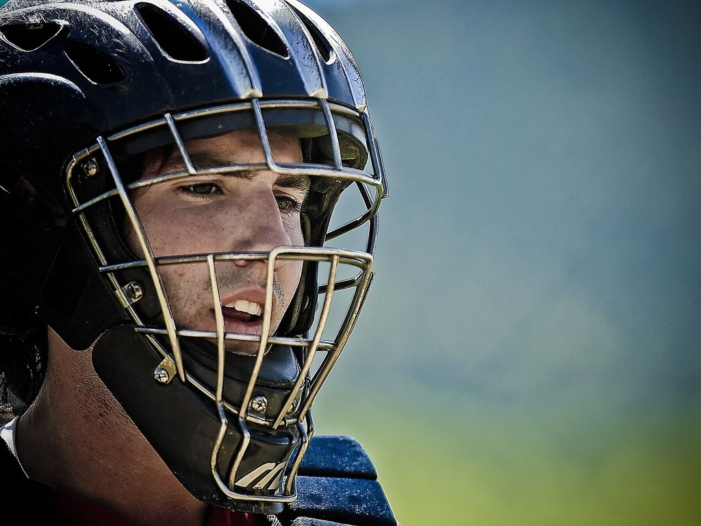 Download A Baseball Player Wearing A Gold Catchers Mask Wallpaper