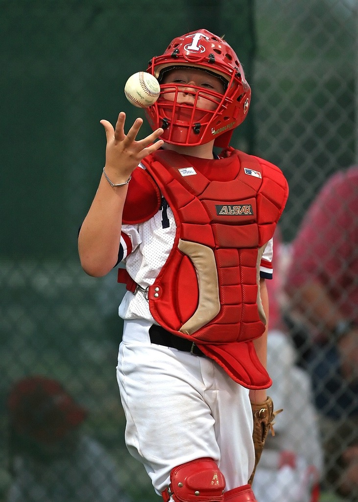 Download A Baseball Player In Red Gear Is Ready To Catch A Ball