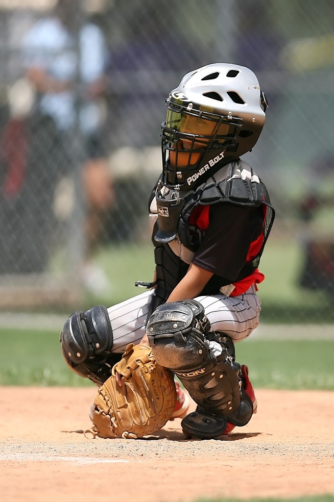 Download A Baseball Player Wearing A Gold Catchers Mask Wallpaper