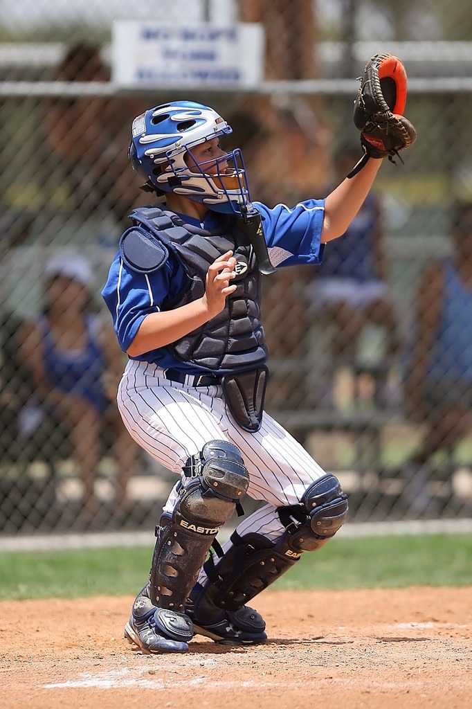 Download A Baseball Player Wearing A Gold Catchers Mask Wallpaper