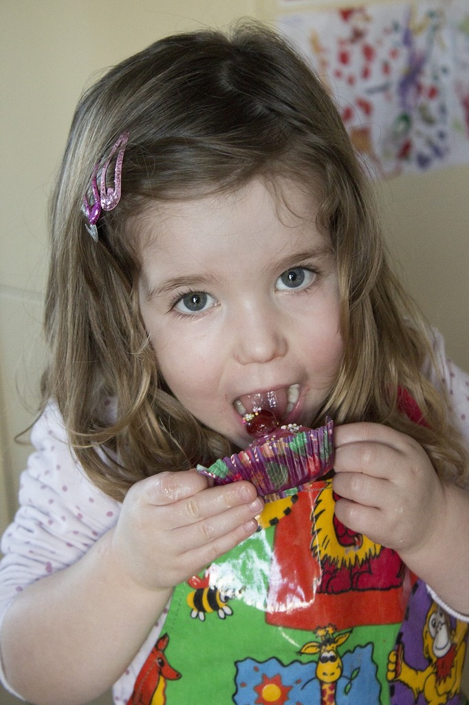 little girl eating cake