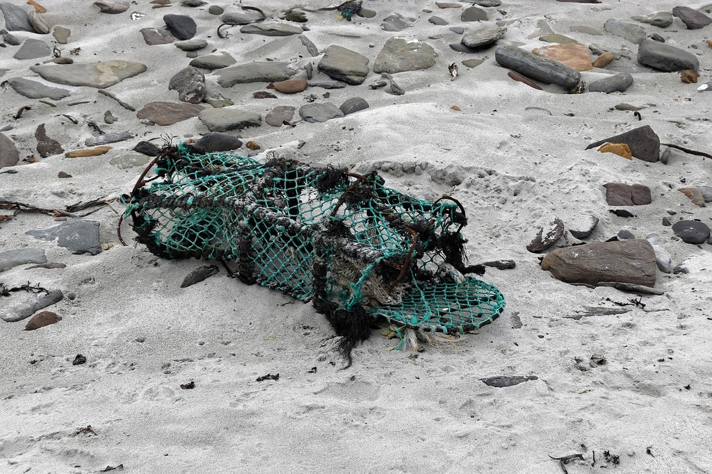 A pile of fishing nets sitting on top of a rock. Creel fishing trap, work.  - PICRYL - Public Domain Media Search Engine Public Domain Search