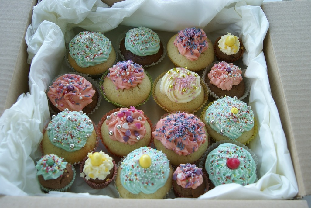 A box filled with lots of cupcakes covered in frosting. Cupcakes colorful  color. - PICRYL - Public Domain Media Search Engine Public Domain Image