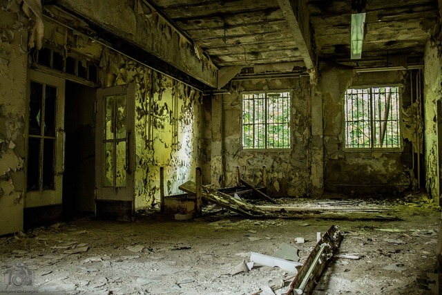 Dilapidated ruin barracks building. A room with a bunch of broken ...