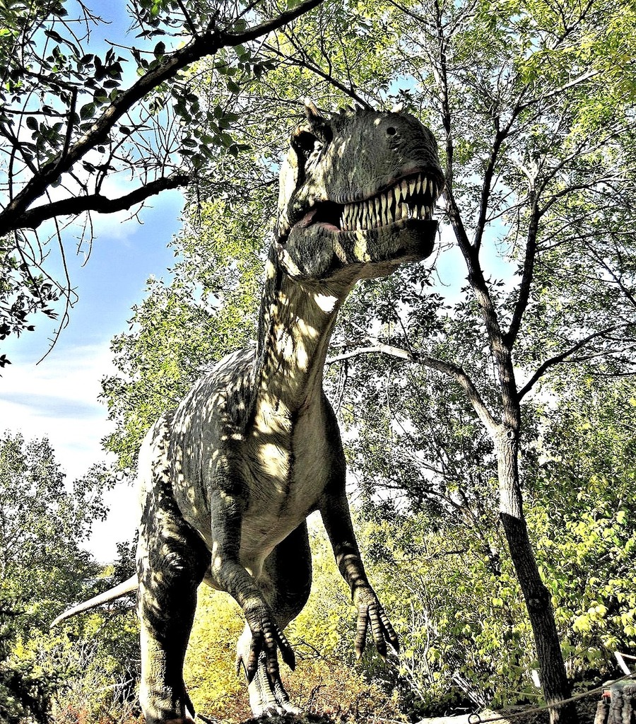 A fake t - rex with its mouth open next to a tree. Rex dino t rex. - PICRYL  - Public Domain Media Search Engine Public Domain Search