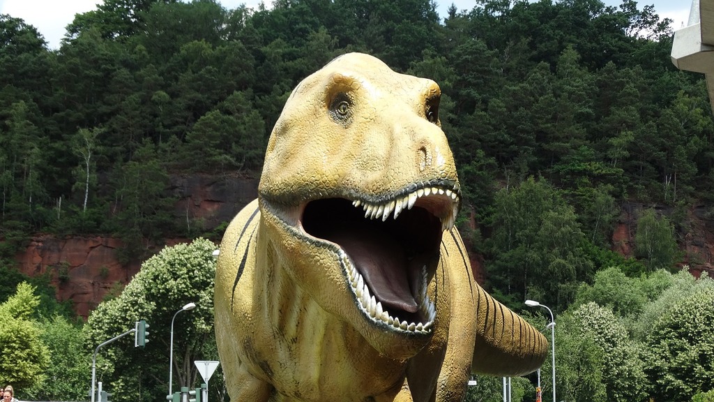 A fake t - rex with its mouth open next to a tree. Rex dino t rex. - PICRYL  - Public Domain Media Search Engine Public Domain Search