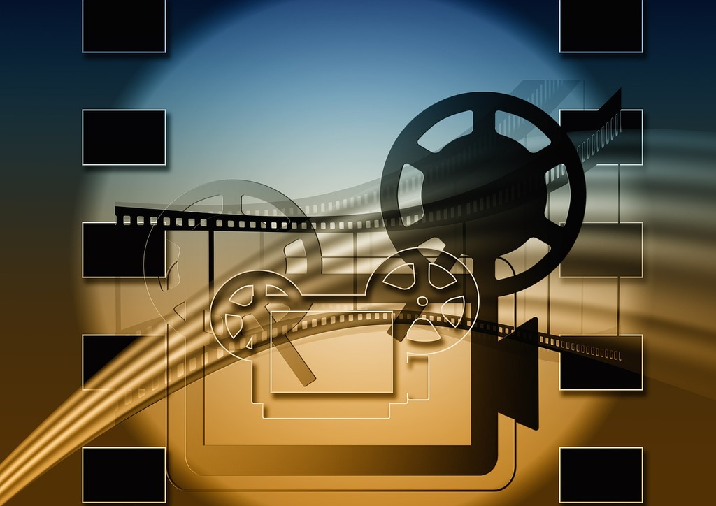 A picture of a film reel and a film strip. Film projector movie