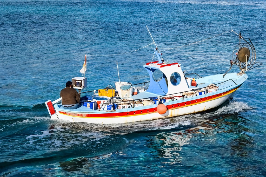 A small boat in the middle of the ocean. Fishing boat traditional
