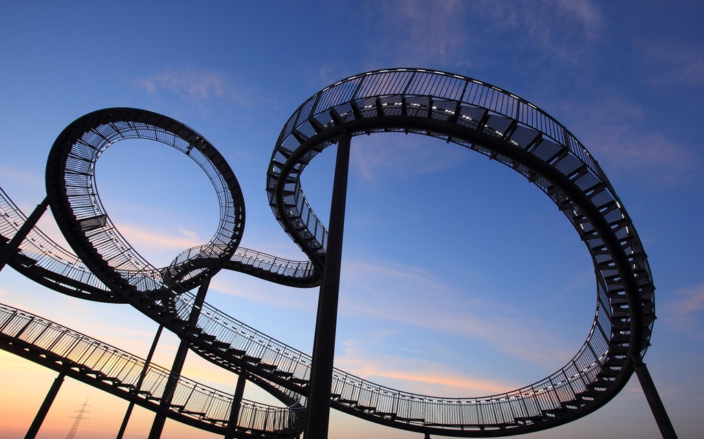 A roller coaster in a park with a sunset in the background Germany