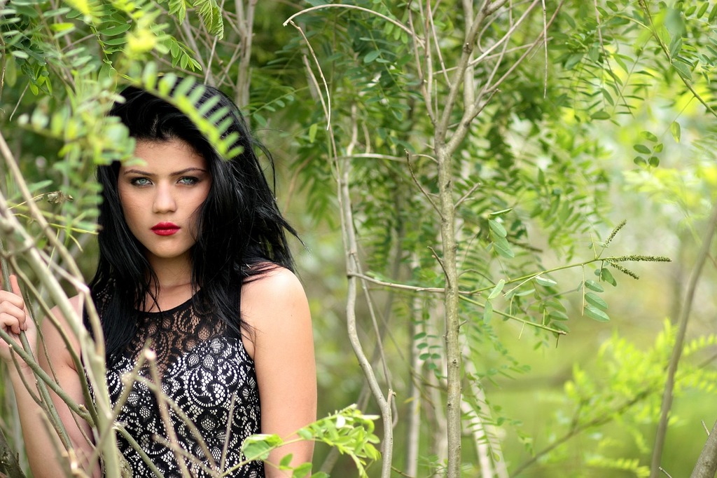 A pretty black girl in a black dress in a forest, sc
