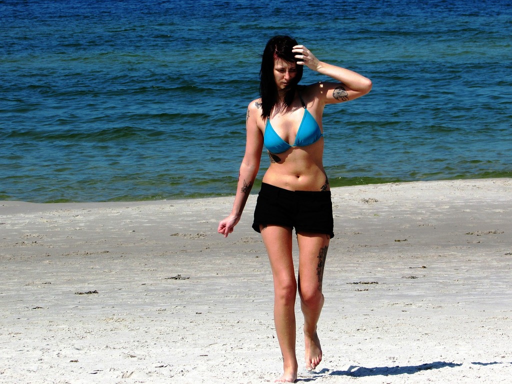 A woman in a blue bikini walking on a beach. Girl young beach, people. -  PICRYL - Public Domain Media Search Engine Public Domain Image