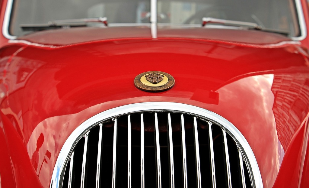 A close up of a red car with a badge on it. Jaguar oldtimer red. - PICRYL -  Public Domain Media Search Engine Public Domain Image