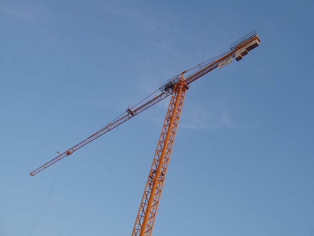 crane on blue sky hook lifting equipment construction industry Stock Photo