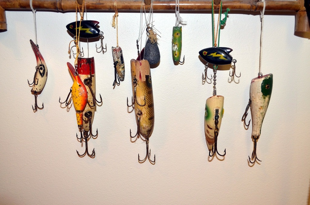 A bunch of fishing lures hanging on a wall. Lure fishing fish