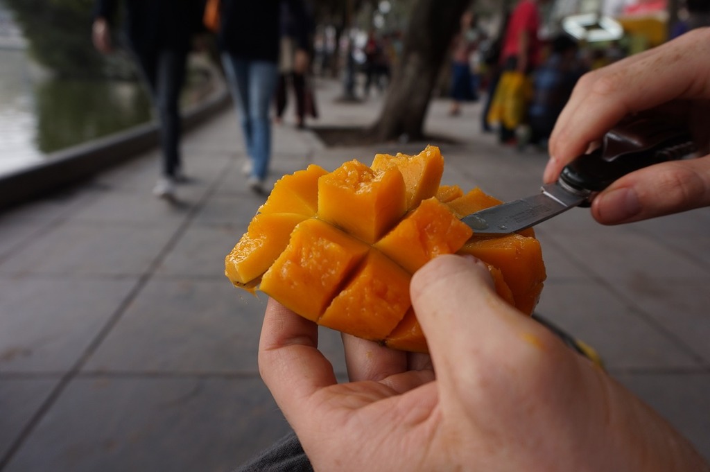 A person cutting a mango with a knife. Mango fruit vegan. - PICRYL - Public  Domain Media Search Engine Public Domain Search