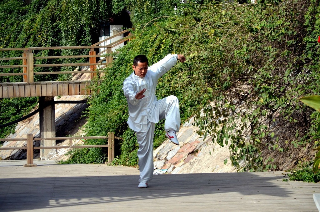 A man in a white suit doing a karate pose. People china kung fu. - PICRYL -  Public Domain Media Search Engine Public Domain Image