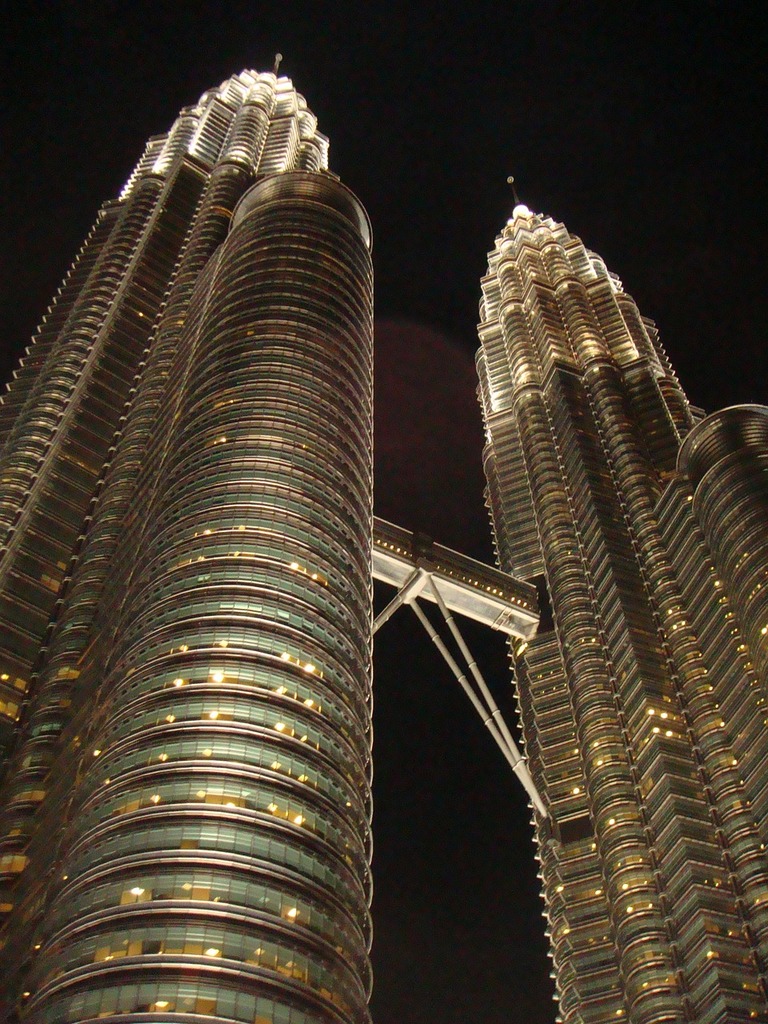 Petronas towers building tower building. A couple of tall buildings lit ...