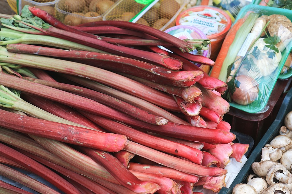 A pile of rhubars and other vegetables on display. Rhubarb market