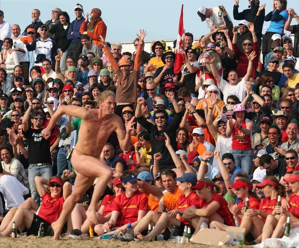 A naked man running in front of a crowd of people. Rimini beach events -  PICRYL - Public Domain Media Search Engine Public Domain Image