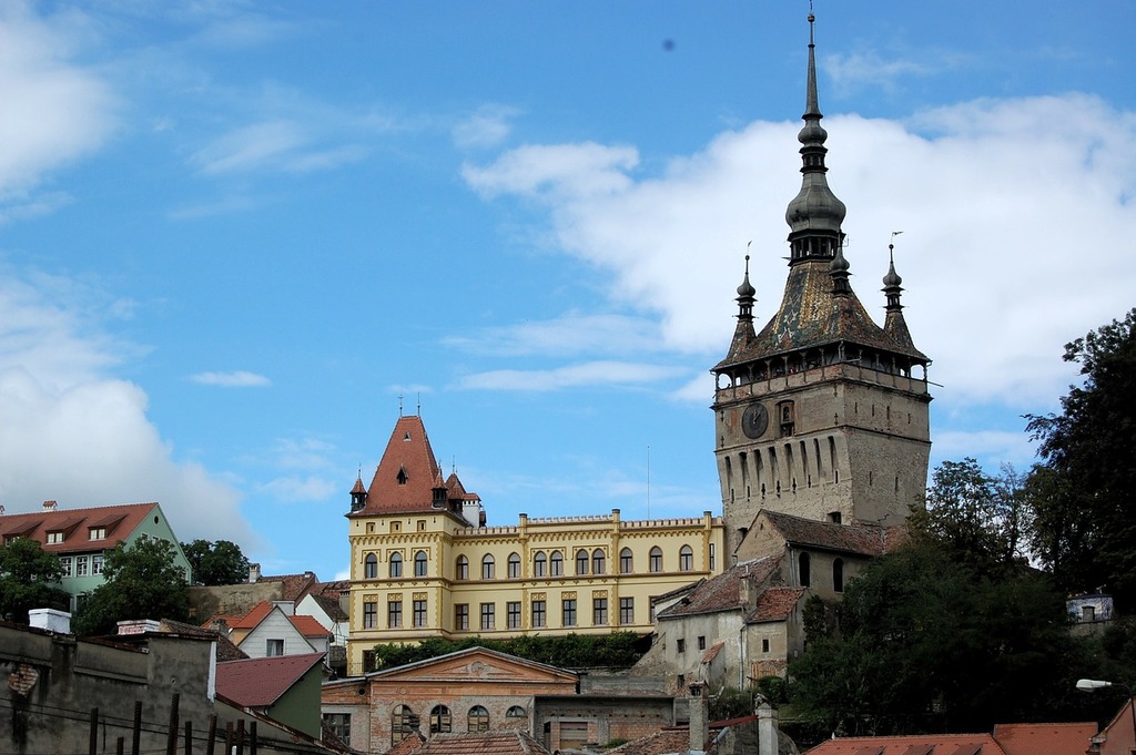 A large building with a clock tower in front of it. Romania sighisoara travel - PICRYL - Public Domain Media Search Engine Public Domain Search