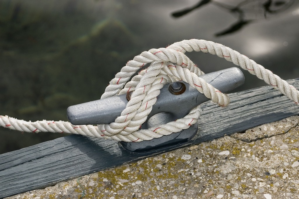A close up of a rope on a boat. Rope cleat dock. - PICRYL - Public
