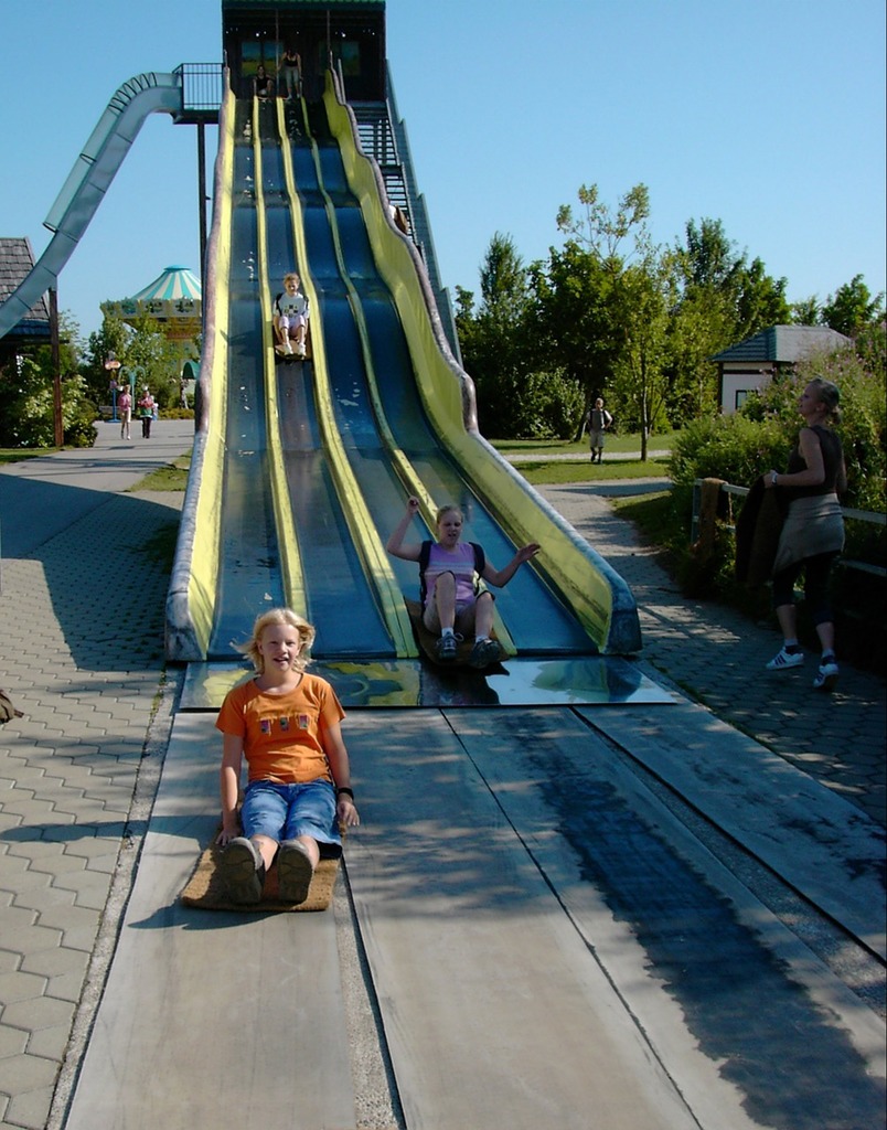 A little girl sitting on a slide in a park. Slide slip girl, people. -  PICRYL - Public Domain Media Search Engine Public Domain Search