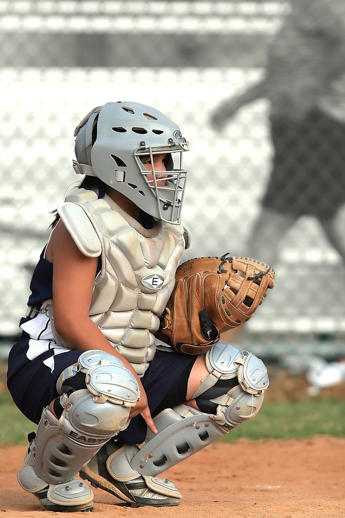 Download A Baseball Player Wearing A Gold Catchers Mask Wallpaper