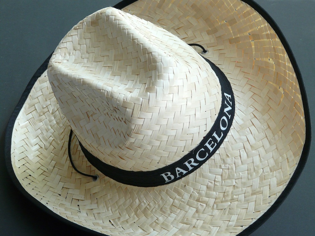 A straw hat with the word barcelona on it. Straw hat hat sun hat