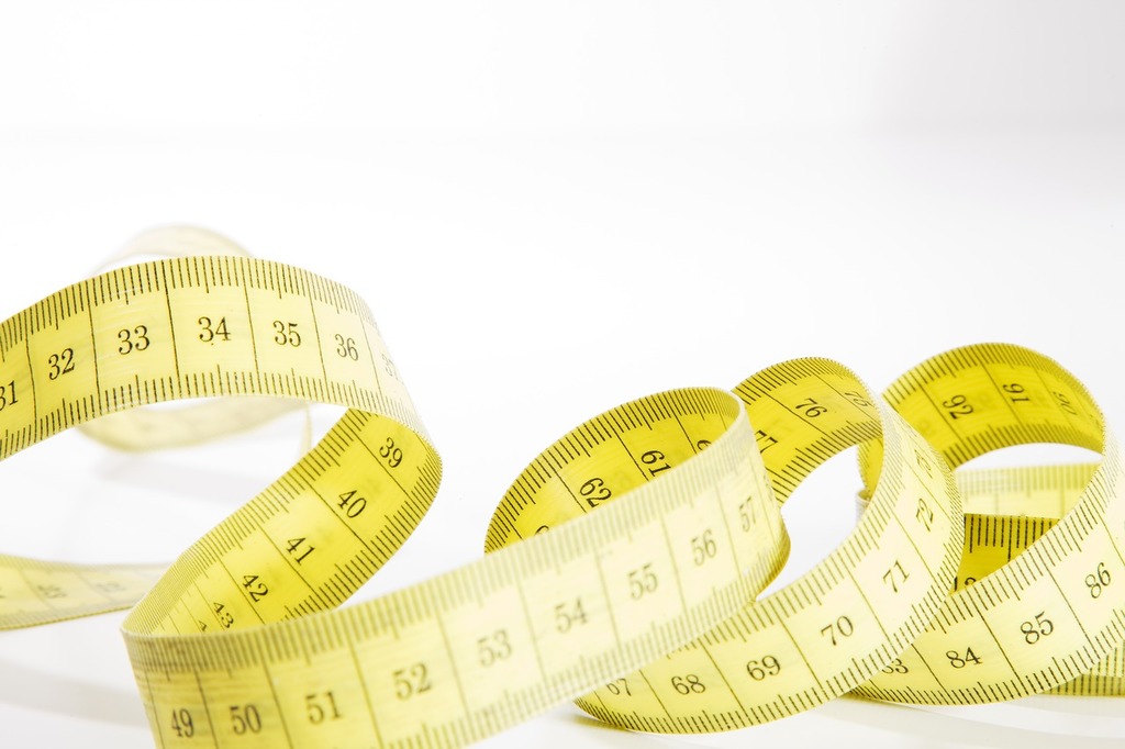 A Close Up Of A Yellow Metric Tape Measure With A White Hand, Metric Tape  Measure 