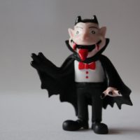 A cartoon of a man standing in front of a house. Count dracula halloween  vampire. - PICRYL - Public Domain Media Search Engine Public Domain Search
