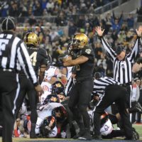 File:American football official signals a touchdown.jpg